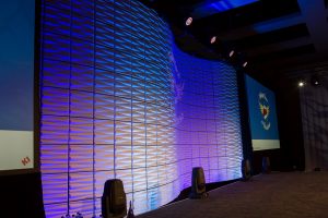 LED lighting projected onto the curved wall and custom lighting was used throughout the week long conference.